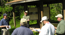 Forestry Program Manager Tom Pavlesich (at left) explains the benefits of foresty best management practices at Lennox Model Forest.